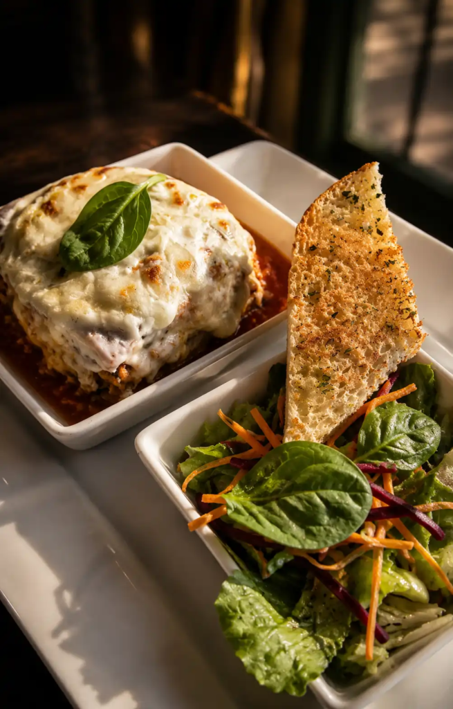 Chicken Lasagna at Toscano Amanora featured in our Toscano Pune review, served with fresh salad and garlic bread.